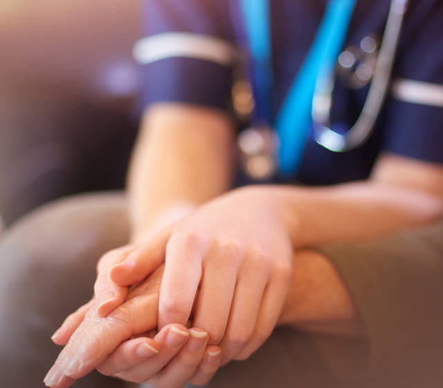Nurse holding patients hands Nurse holding patients hands