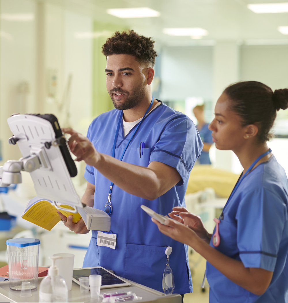 A nurse caring for a patient on a hospital ward